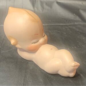 Kewpie baby laying down on back relaxing. Bisque 1994